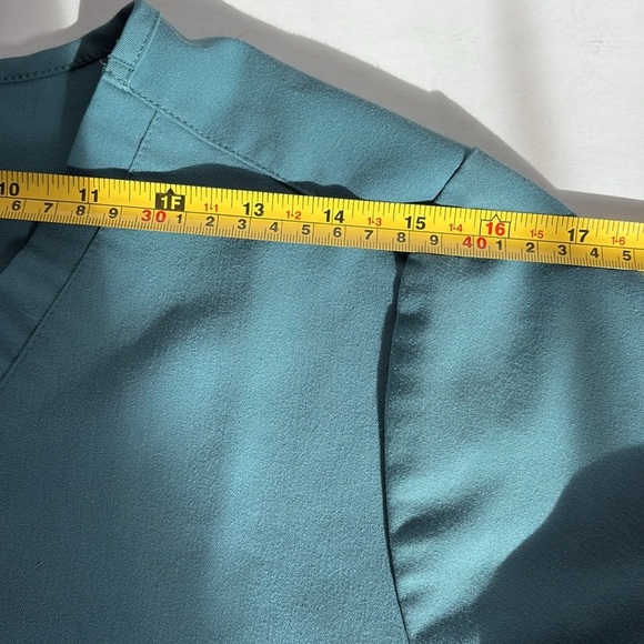 FIGS v-neck short sleeve two front pocket scrub shirt in a blue green color - Picture 14 of 16